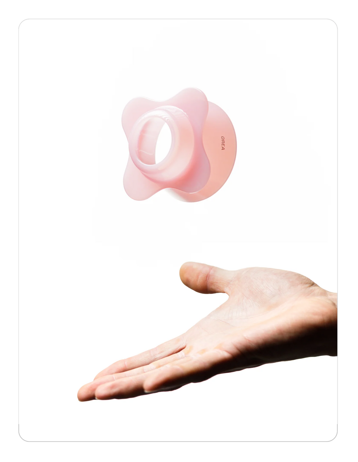 Creamy pink OREA 01 brewer on a hand against a white background