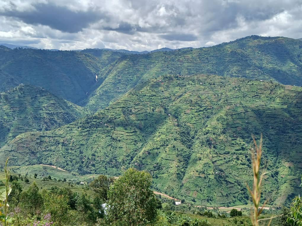 Green mountainous landscape of Bukanda Hill with clouds in the sky