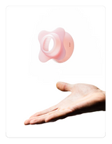 Creamy pink OREA 01 brewer on a hand against a white background