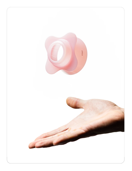 Creamy pink OREA 01 brewer on a hand against a white background