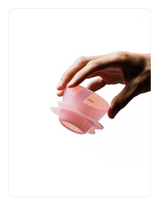 Hand holding a Creamy pink OREA 01 brewer on a white background
